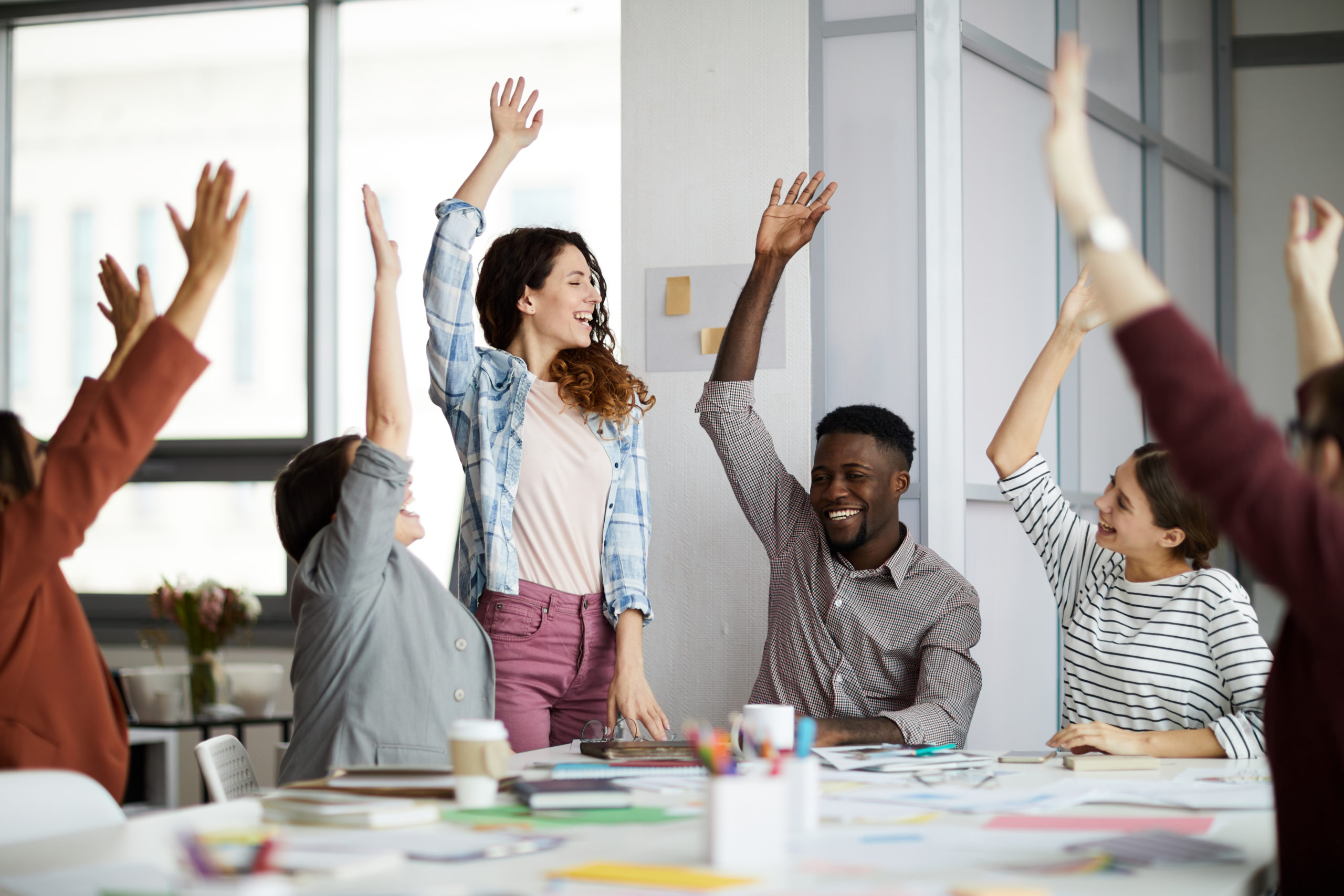 contemporary-business-people-raising-hands-2021-09-24-04-00-41-utc-scaled.jpg